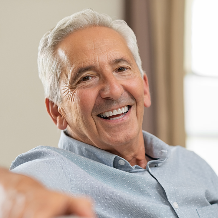 Smiling elderly man in a blue shirt